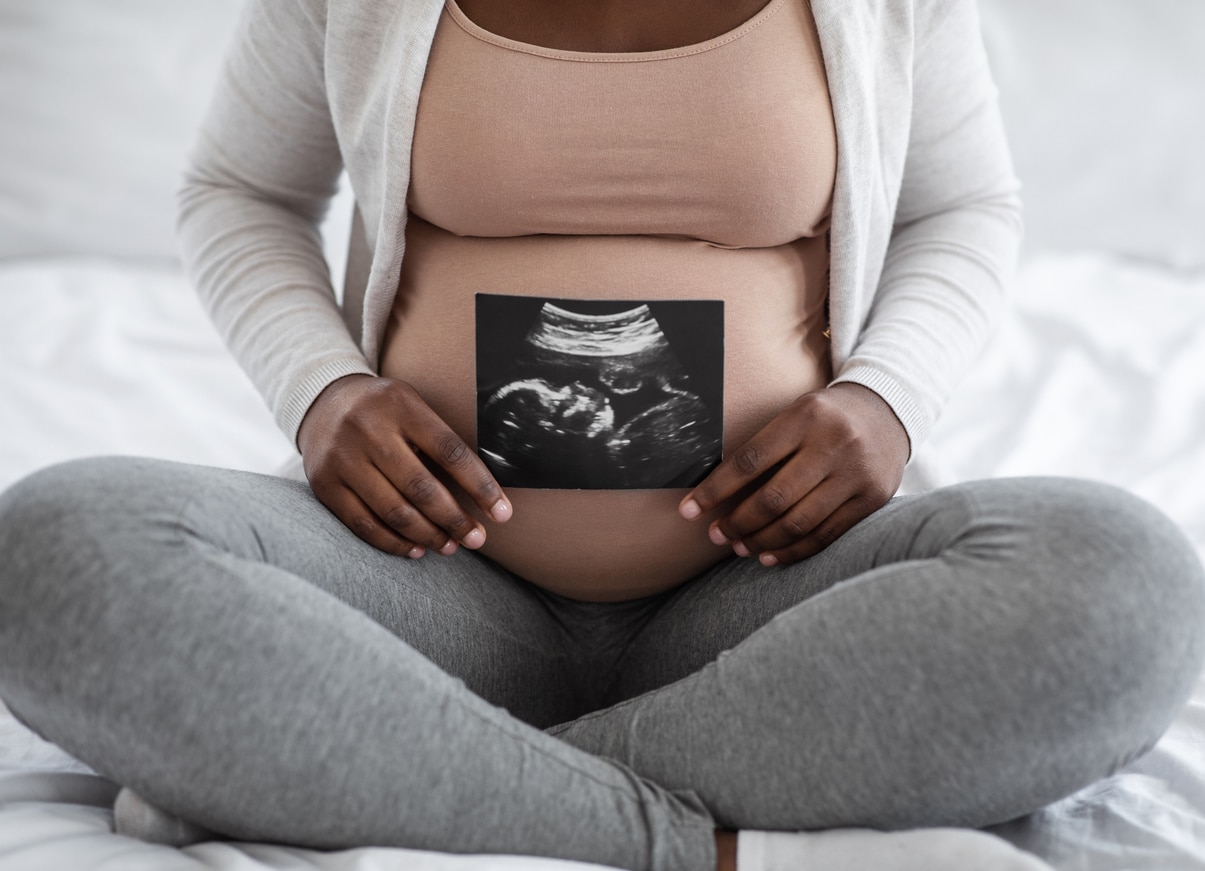 Woman holding baby sonography photo